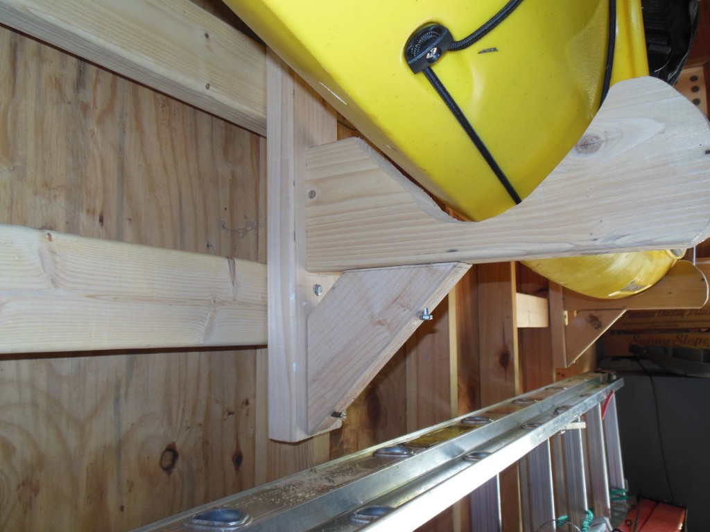 I copied this rack from one I saw for sale online. The vertical piece (abouty 20" long) and the angled support are made from 2x4. The horizontal arm is from 2x6. Lag bolts hold it together. The contour is fitted to my boat so it is very stable.